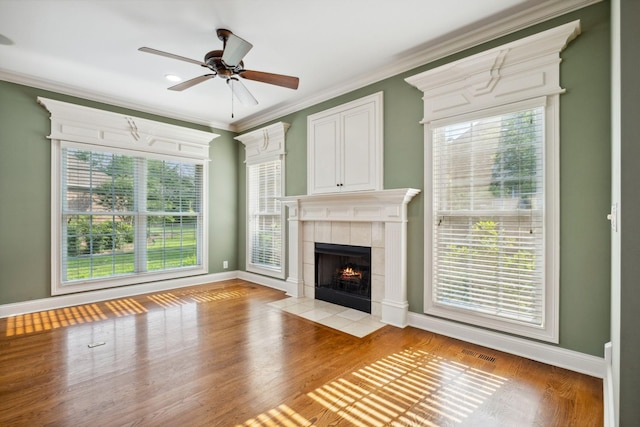 3334 Granite Springs Way, Murfreesboro, TN 37130 - unfurnished living room featuring a tile fireplace, ceiling fan, crown molding, baseboards, and light wood-type flooring