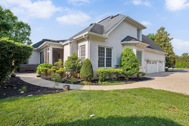 3334 Granite Springs Way, Murfreesboro, TN 37130 - view of side of home with a hot tub, brick siding, driveway, a garage, and a lawn
