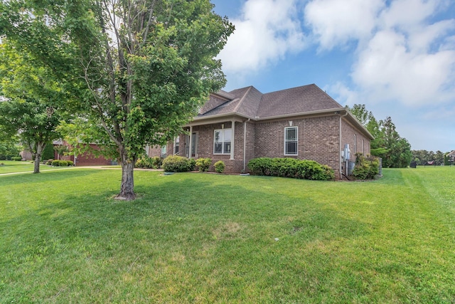 525 Amberly St, Murfreesboro, TN 37129 - view of front facade with a front lawn, brick siding, and a shingled roof