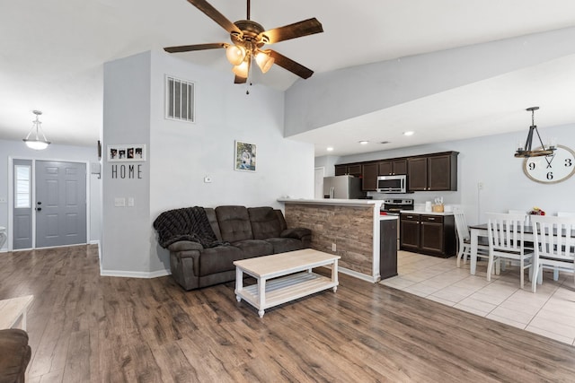 105 Patana Dr, White House, TN 37188 - living area with ceiling fan, wood finished floors, high vaulted ceiling, a chandelier, and baseboards