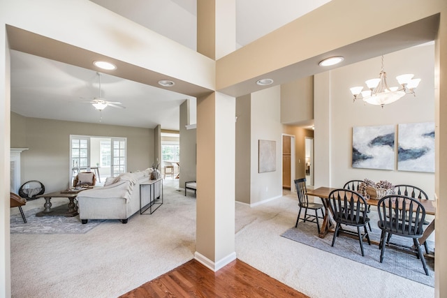 3505 Grove Park Dr, College Grove, TN 37046 - dining area with carpet, a ceiling fan, a chandelier, wood finished floors, and baseboards