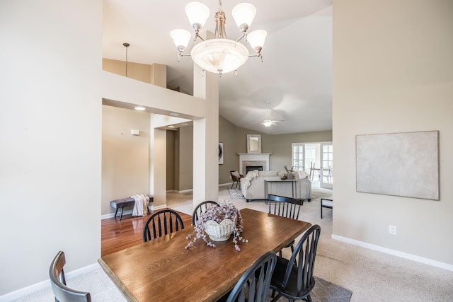 3505 Grove Park Dr, College Grove, TN 37046 - dining space featuring a fireplace, baseboards, a chandelier, and high vaulted ceiling