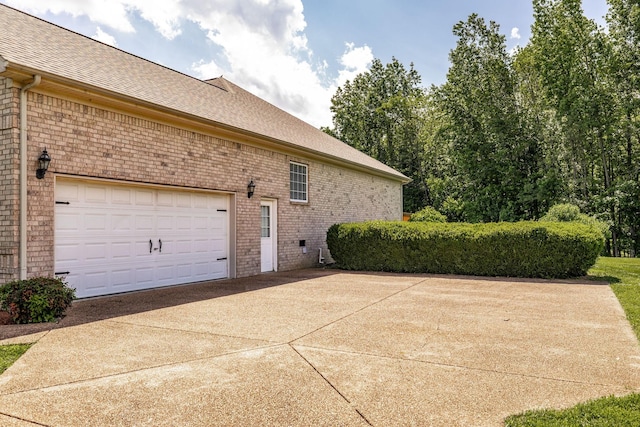 3505 Grove Park Dr, College Grove, TN 37046 - view of side of home featuring concrete driveway, brick siding, a shingled roof, and a garage