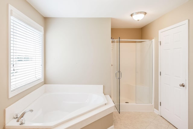 3505 Grove Park Dr, College Grove, TN 37046 - full bathroom with healthy amount of natural light, a shower stall, a garden tub, and tile patterned floors