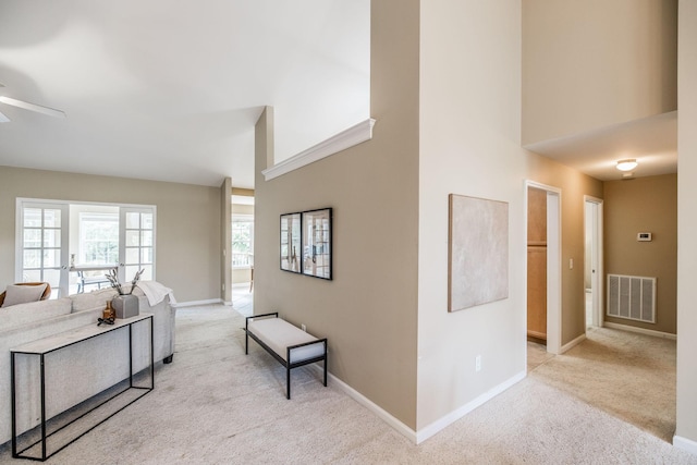3505 Grove Park Dr, College Grove, TN 37046 - living room featuring light colored carpet, a ceiling fan, a high ceiling, and baseboards