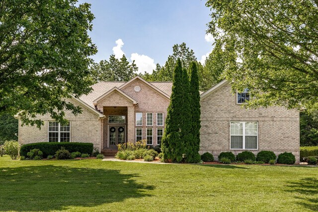 3505 Grove Park Dr, College Grove, TN 37046 - traditional home featuring brick siding, a front lawn, and french doors
