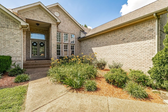 3505 Grove Park Dr, College Grove, TN 37046 - view of exterior entry featuring french doors, brick siding, and roof with shingles