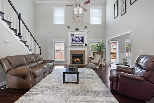 4702 Garcia Blvd, Murfreesboro, TN 37128 - living room with a tiled fireplace, crown molding, a towering ceiling, ceiling fan, and plenty of natural light
