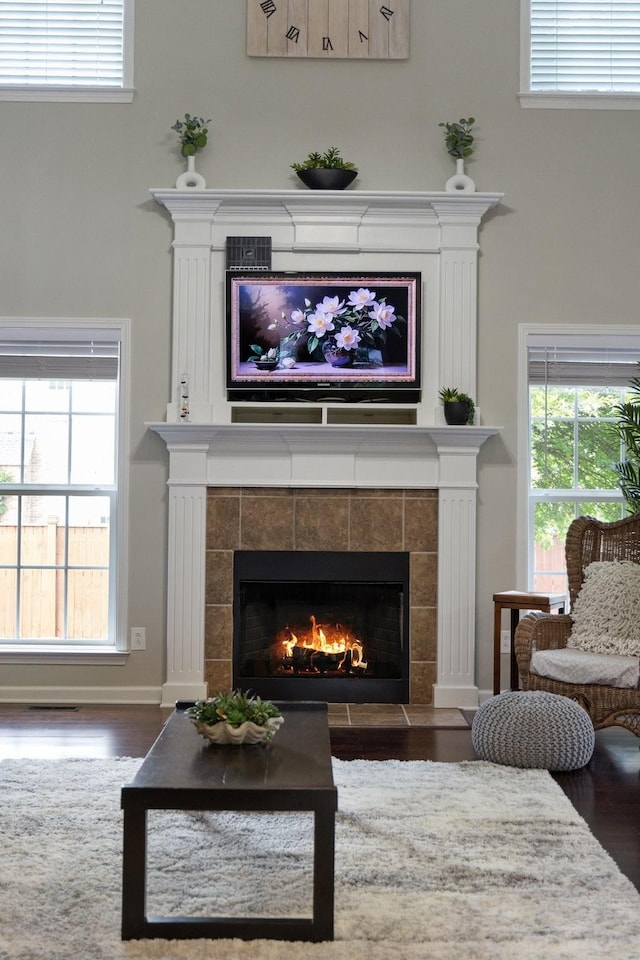 4702 Garcia Blvd, Murfreesboro, TN 37128 - living area featuring a tiled fireplace, wood finished floors, and plenty of natural light