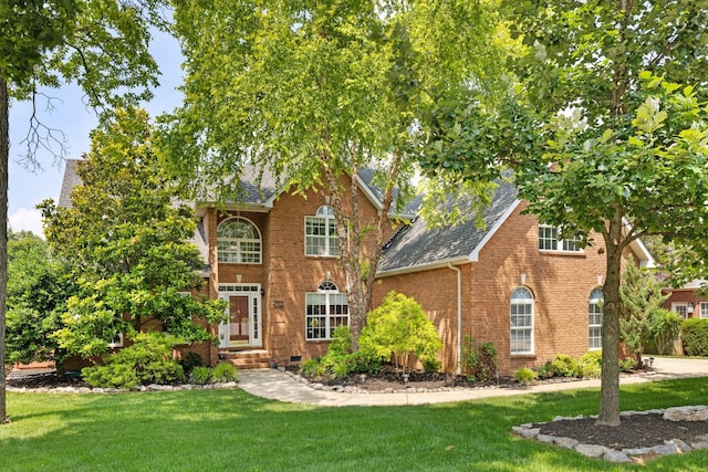 4702 Garcia Blvd, Murfreesboro, TN 37128 - view of front of home with a front lawn, brick siding, and roof with shingles