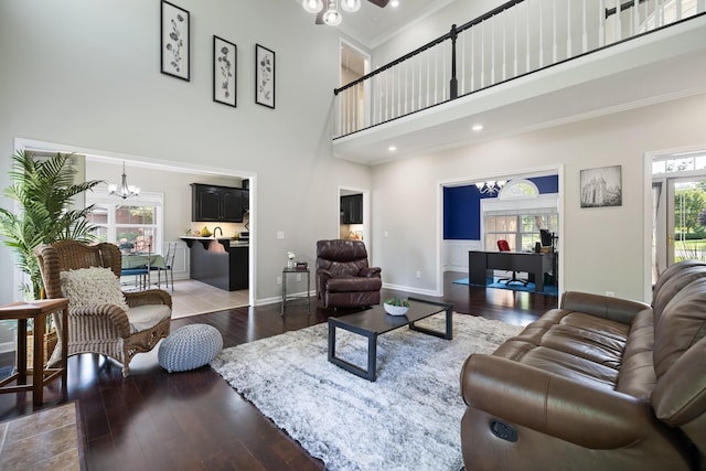 4702 Garcia Blvd, Murfreesboro, TN 37128 - living room featuring a chandelier, a towering ceiling, wood-type flooring, crown molding, and baseboards