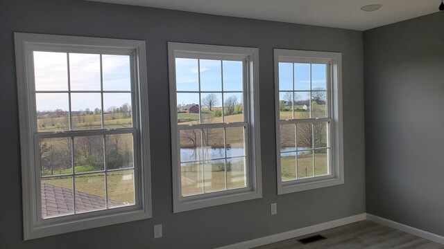 171 Ashmore Rd, Summertown, TN 38483 - detailed view of baseboards, wood finished floors, and a large body of water