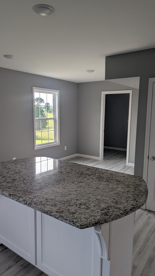 171 Ashmore Rd, Summertown, TN 38483 - kitchen featuring light wood-style flooring, light stone counters, and baseboards