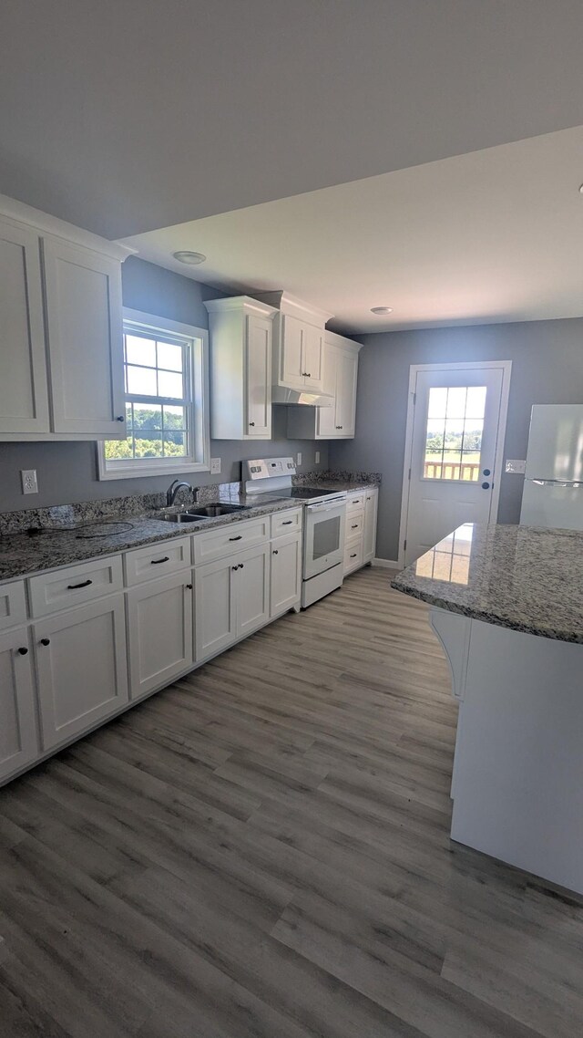 171 Ashmore Rd, Summertown, TN 38483 - kitchen featuring white range with electric stovetop, fridge, a sink, and white cabinetry