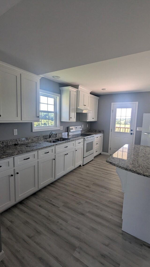 171 Ashmore Rd, Summertown, TN 38483 - kitchen with white electric stove, a sink, white cabinets, wood finished floors, and light stone countertops