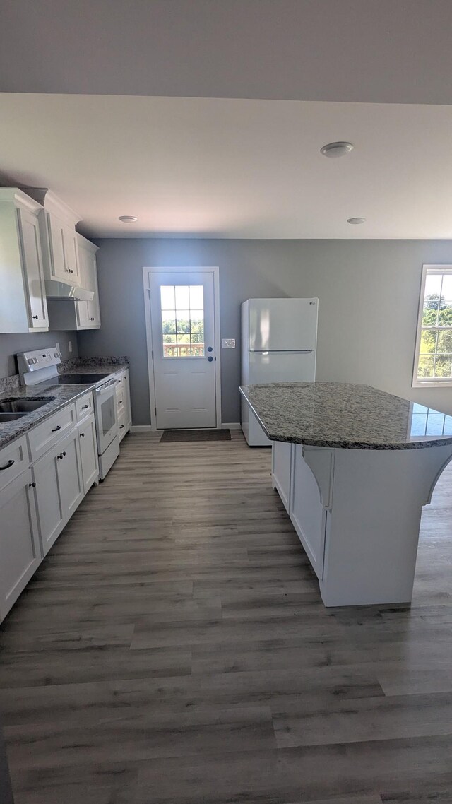 171 Ashmore Rd, Summertown, TN 38483 - kitchen featuring white appliances, wood finished floors, white cabinets, dark stone countertops, and a center island