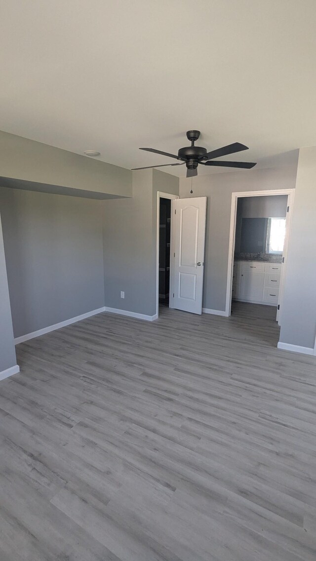 171 Ashmore Rd, Summertown, TN 38483 - unfurnished bedroom with baseboards, wood finished floors, and a ceiling fan