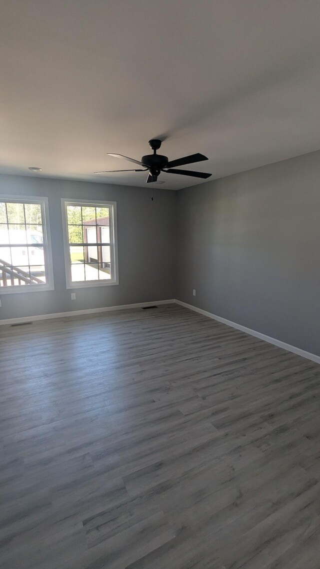171 Ashmore Rd, Summertown, TN 38483 - unfurnished room featuring baseboards, a ceiling fan, and dark wood finished floors