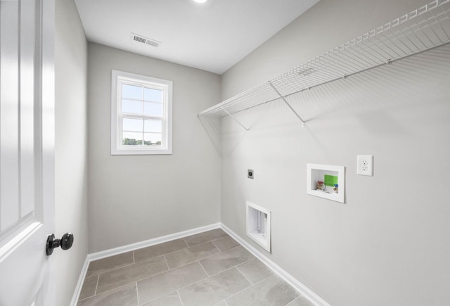 2586 Rafiki Dr, Clarksville, TN 37042 - laundry area featuring electric dryer hookup, hookup for a washing machine, baseboards, and tile patterned flooring