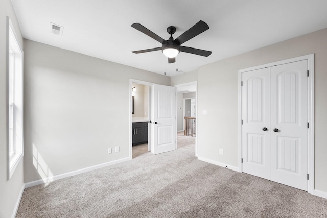 2586 Rafiki Dr, Clarksville, TN 37042 - unfurnished bedroom with light carpet, baseboards, a closet, connected bathroom, and ceiling fan