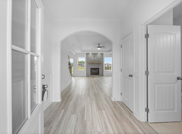 2582 Rafiki Dr, Clarksville, TN 37042 - corridor featuring arched walkways, light wood finished floors, crown molding, and a tray ceiling