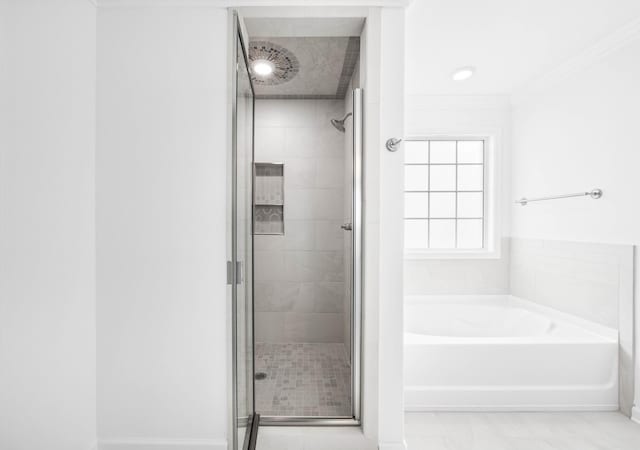 2582 Rafiki Dr, Clarksville, TN 37042 - bathroom with a shower stall, a bath, and ornamental molding