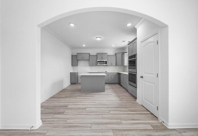 2582 Rafiki Dr, Clarksville, TN 37042 - kitchen featuring gray cabinets, stainless steel appliances, crown molding, a center island, and backsplash