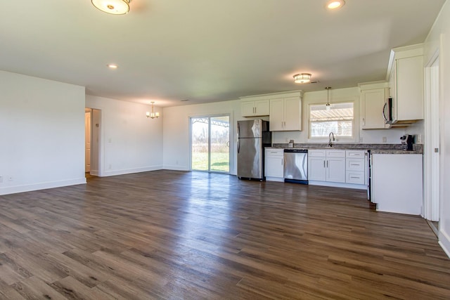 1655 Ben Johns Rd, Smyrna, TN 37167 - kitchen featuring appliances with stainless steel finishes, a chandelier, dark countertops, open floor plan, and healthy amount of natural light