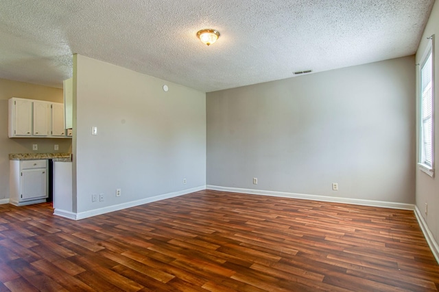 1655 Ben Johns Rd, Smyrna, TN 37167 - empty room featuring dark wood-style flooring, healthy amount of natural light, a textured ceiling, and baseboards