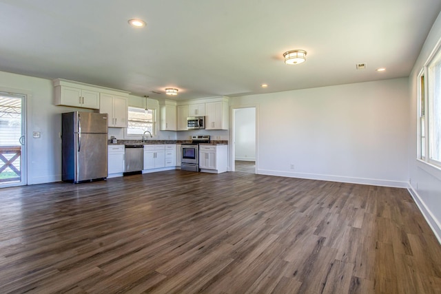 1655 Ben Johns Rd, Smyrna, TN 37167 - kitchen with stainless steel appliances, dark countertops, a sink, white cabinetry, and recessed lighting