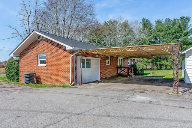 1655 Ben Johns Rd, Smyrna, TN 37167 - view of side of property with brick siding, asphalt driveway, central air condition unit, and a carport