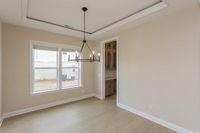 5962 Hunt Valley Dr, Spring Hill, TN 37174 - unfurnished dining area with a tray ceiling, a chandelier, and light wood-style floors