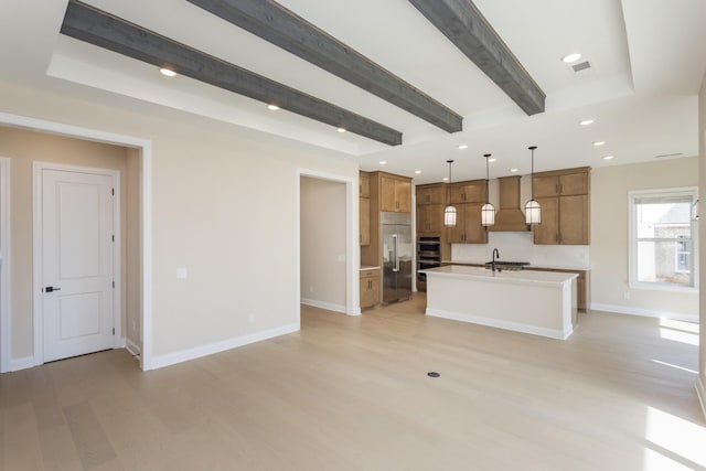 5962 Hunt Valley Dr, Spring Hill, TN 37174 - kitchen with appliances with stainless steel finishes, light wood-style flooring, brown cabinets, custom range hood, and beam ceiling