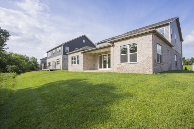 5962 Hunt Valley Dr, Spring Hill, TN 37174 - rear view of house with a lawn and brick siding