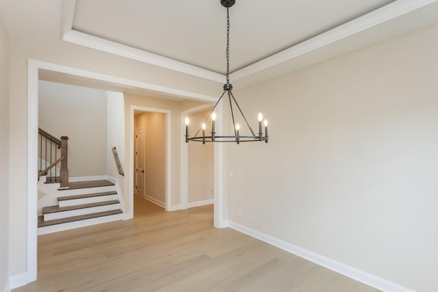 5962 Hunt Valley Dr, Spring Hill, TN 37174 - unfurnished dining area with a chandelier, light wood-type flooring, stairway, and baseboards