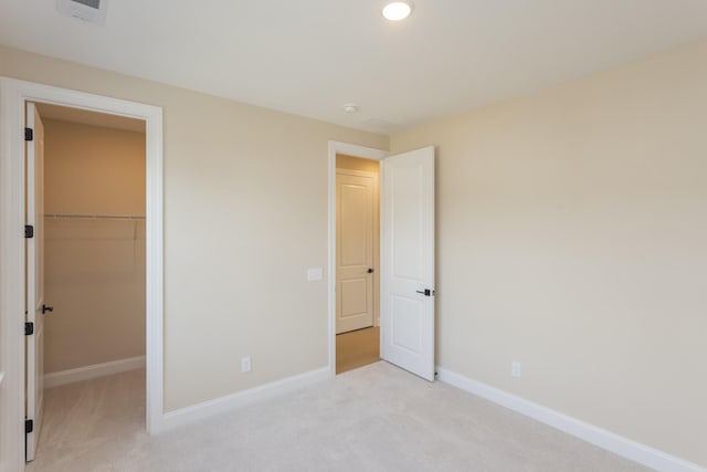 5962 Hunt Valley Dr, Spring Hill, TN 37174 - unfurnished bedroom featuring a walk in closet, light carpet, baseboards, a closet, and recessed lighting
