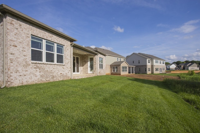 5962 Hunt Valley Dr, Spring Hill, TN 37174 - rear view of property featuring a lawn, brick siding, and a residential view