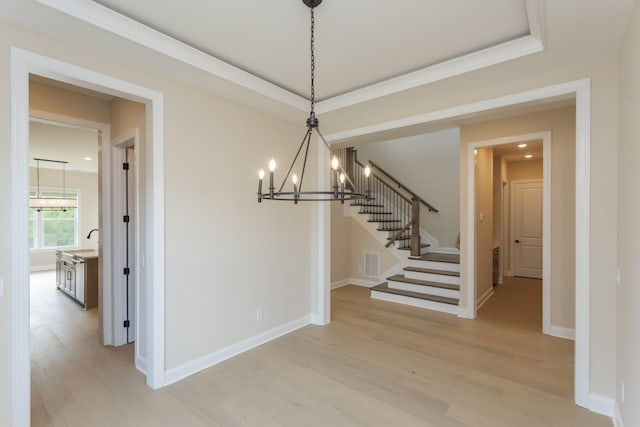 5962 Hunt Valley Dr, Spring Hill, TN 37174 - unfurnished dining area with light wood-style floors, a chandelier, stairs, baseboards, and crown molding