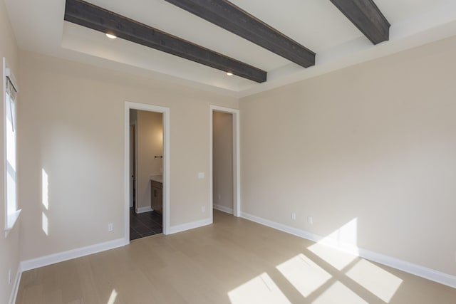 5962 Hunt Valley Dr, Spring Hill, TN 37174 - unfurnished bedroom featuring beam ceiling, light wood finished floors, connected bathroom, and baseboards