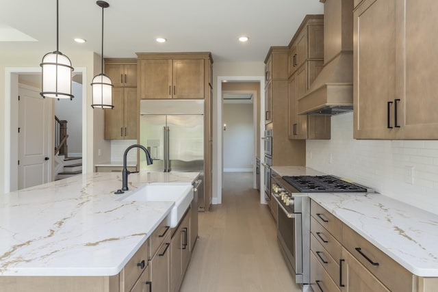 5962 Hunt Valley Dr, Spring Hill, TN 37174 - kitchen featuring custom range hood, premium appliances, a large island, baseboards, and light wood-style flooring