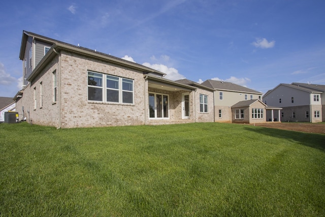 5962 Hunt Valley Dr, Spring Hill, TN 37174 - back of property with central AC unit, a yard, and brick siding