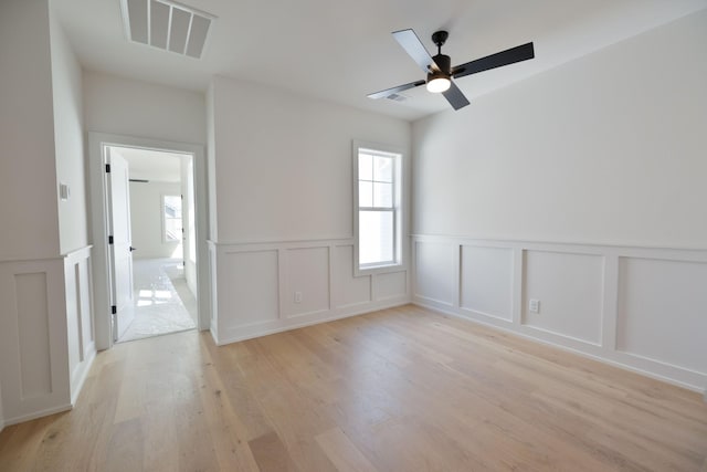 4072 Penfield Dr Unit B, Franklin, TN 37069 - empty room featuring light wood-style flooring, wainscoting, a decorative wall, and ceiling fan