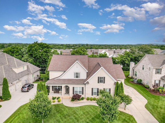 813 Stone Mill Cir, Murfreesboro, TN 37130 - view of front of house with covered porch, board and batten siding, concrete driveway, a residential view, and brick siding