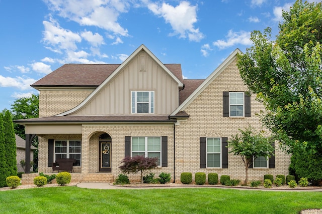 813 Stone Mill Cir, Murfreesboro, TN 37130 - view of front facade with board and batten siding, a front lawn, a porch, brick siding, and a shingled roof