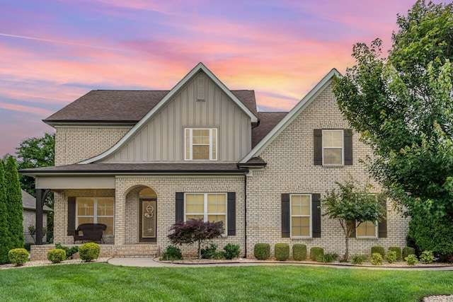 813 Stone Mill Cir, Murfreesboro, TN 37130 - view of front of property with board and batten siding, a yard, covered porch, brick siding, and roof with shingles