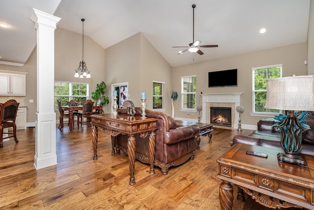 813 Stone Mill Cir, Murfreesboro, TN 37130 - living area featuring decorative columns, ceiling fan, high vaulted ceiling, a chandelier, and a lit fireplace
