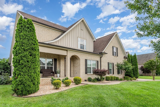 813 Stone Mill Cir, Murfreesboro, TN 37130 - view of front facade with board and batten siding, brick siding, a front lawn, covered porch, and a shingled roof