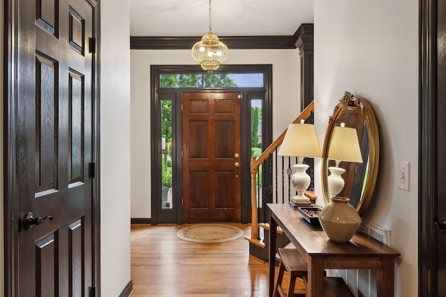 6781 Autumnwood Dr, Nashville, TN 37221 - foyer featuring wood finished floors, ornamental molding, a chandelier, and baseboards