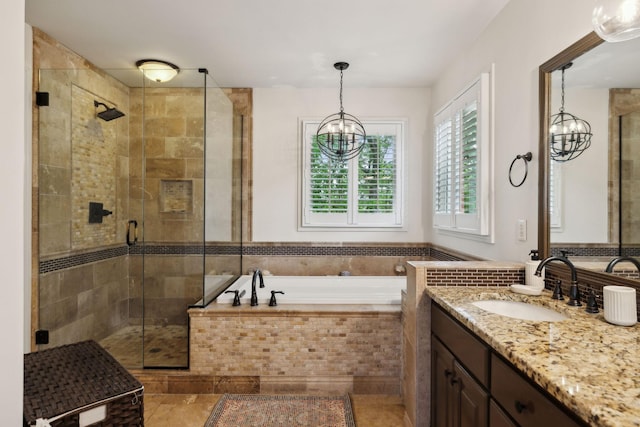 6781 Autumnwood Dr, Nashville, TN 37221 - bathroom with a chandelier, vanity, a bath, and a stall shower