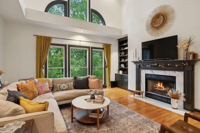 6781 Autumnwood Dr, Nashville, TN 37221 - living area with wood finished floors, a high end fireplace, built in features, and a high ceiling